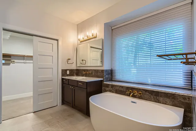 a bathroom with a bathtub and a sink