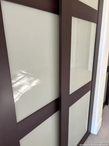 a bathroom with a sink a toilet a mirror and shower