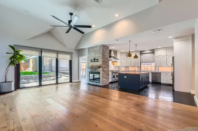 a view of a living room and kitchen with furniture wooden floor