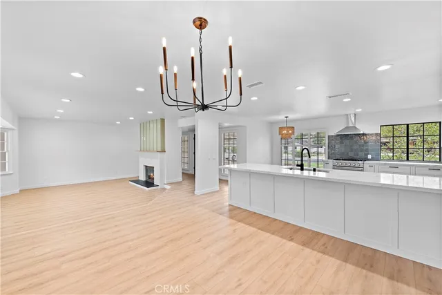 a large kitchen with stainless steel appliances kitchen island granite countertop a stove and a sink