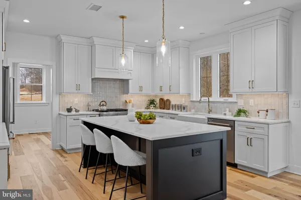 a kitchen with a sink a stove a dining table and chairs