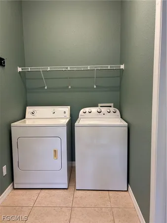a bedroom with a bed table and window
