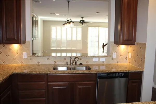a view of empty room with window and wooden floor