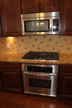 a kitchen with granite countertop a sink and a wooden cabinets