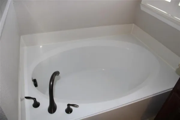 a bathroom with a bathtub and a window