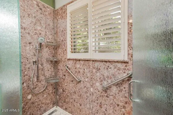 a view of walk in closet with clothes