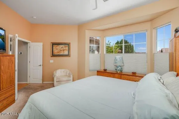 a spacious bedroom with a bed and a window