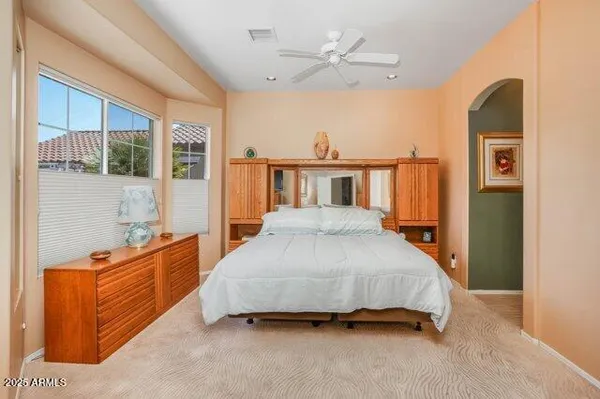 a bedroom with furniture and a window