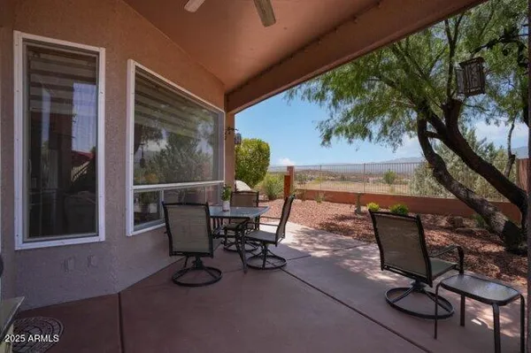 a backyard of a house with table and chairs