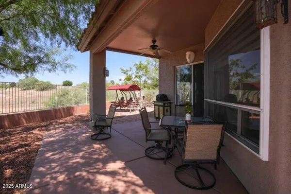 a backyard of a house with table and chairs