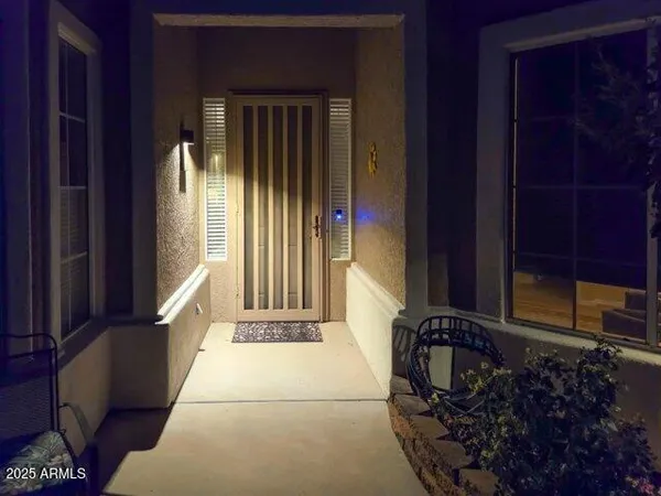 a living room with furniture kitchen view and a large window