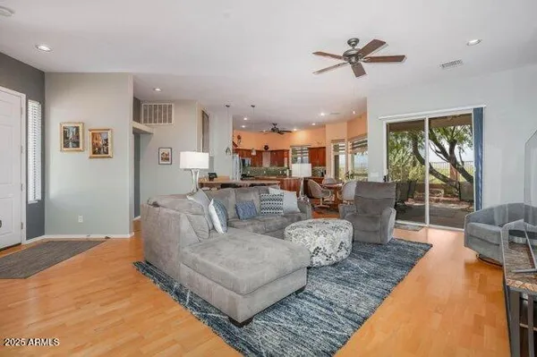 a living room with fireplace furniture and a large window