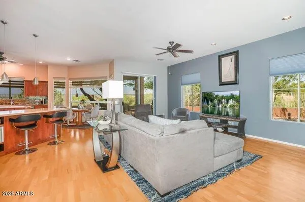 a open kitchen with stainless steel appliances kitchen island granite countertop a table chairs sink and cabinets