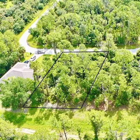 a backyard of a house with lots of green space and plants