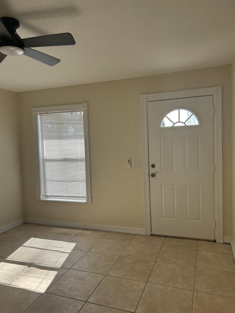 6793 4th Street Jupiter, FL 33458 - Photo 2 of 14 a view of an empty room with a window