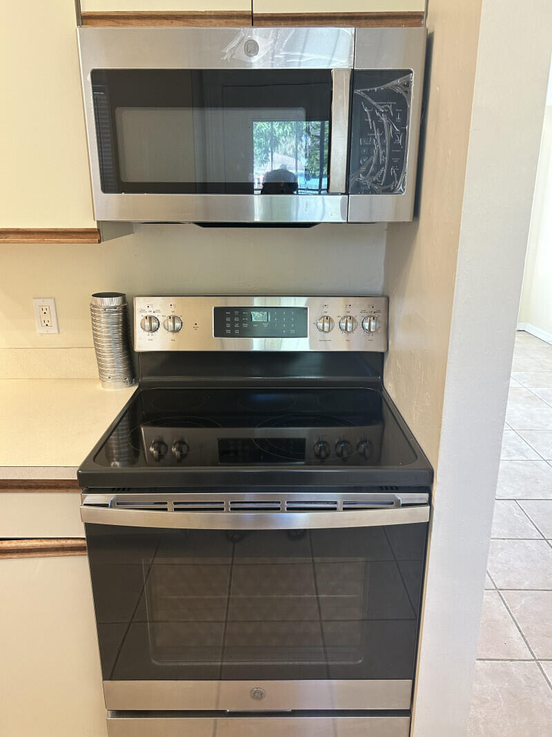 6793 4th Street Jupiter, FL 33458 - Photo 4 of 14 a stove top oven sitting inside of a kitchen