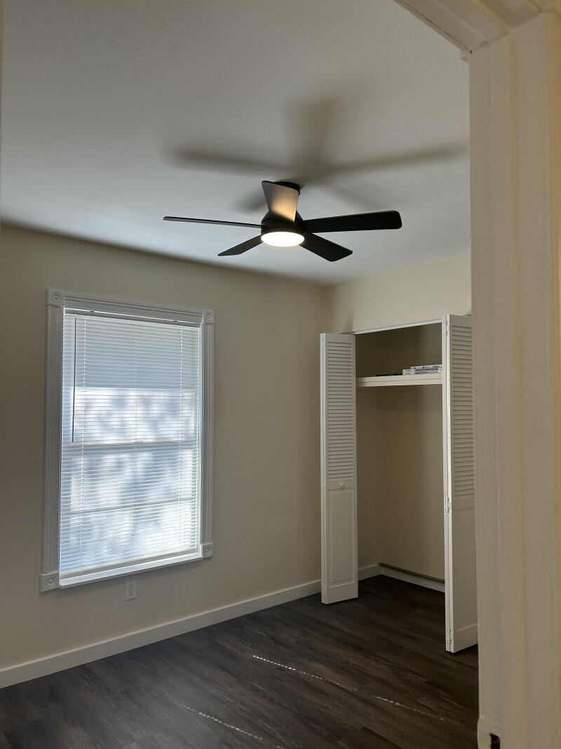 6793 4th Street Jupiter, FL 33458 - Photo 9 of 14 an empty room with wooden floor and windows