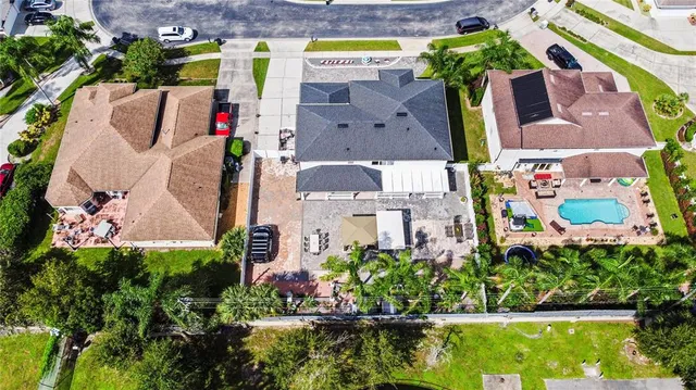 an aerial view of residential houses with outdoor space and swimming pool