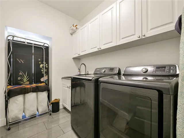 a dining room with furniture and a chandelier fan