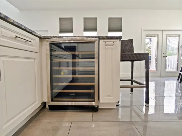 a kitchen with kitchen island granite countertop a sink a counter top space and cabinets