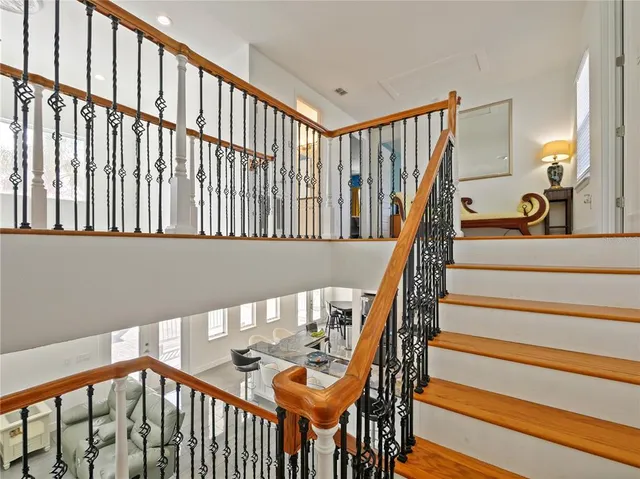 a bedroom with a bed and painting on the wall