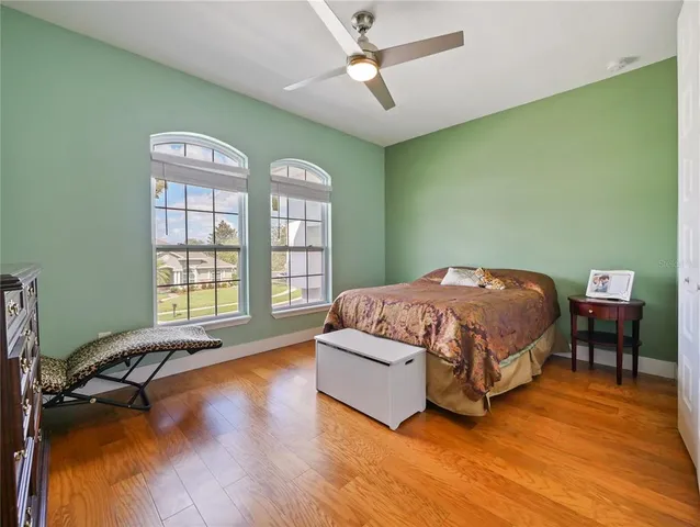 a bathroom with a granite countertop sink a toilet and mirror