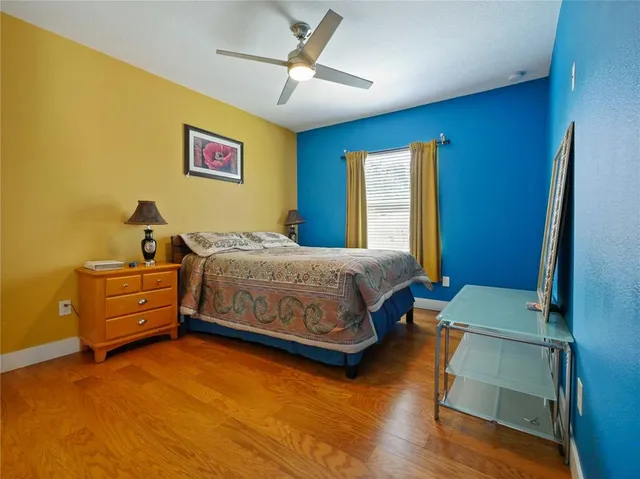 a bedroom with a bed and a painting on the wall