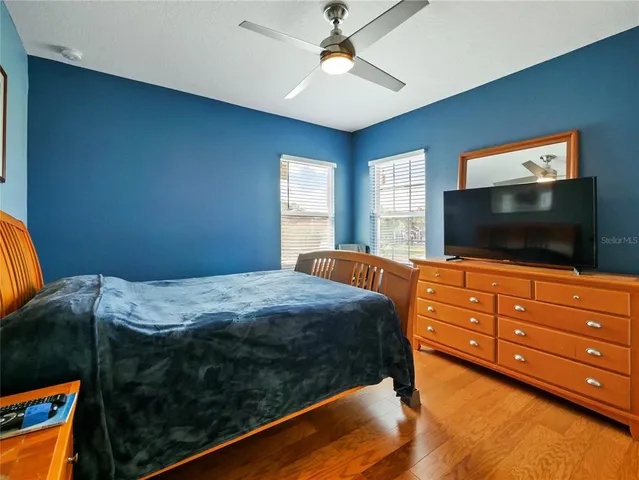 a bedroom with a bed and a large window