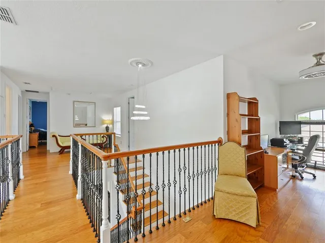 a view of a workspace with furniture and a window