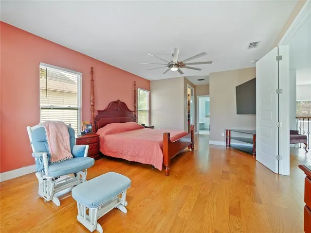 a bedroom with furniture and a wooden floor
