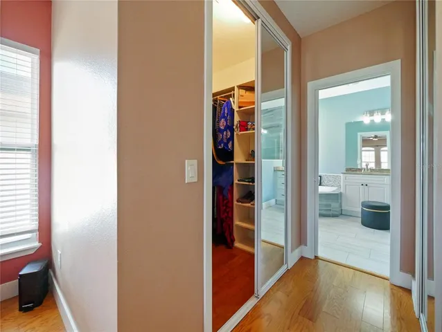 a utility room with closet dryer and painting on the wall