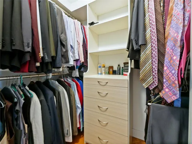a bathroom with a granite countertop sink a mirror and shower