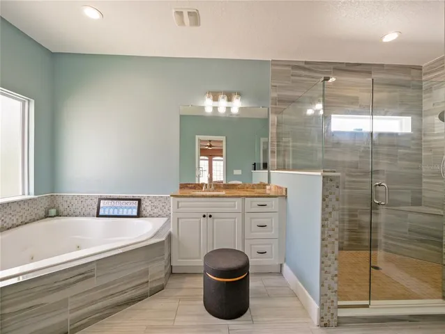 a bathroom with a sink a toilet a mirror and shower