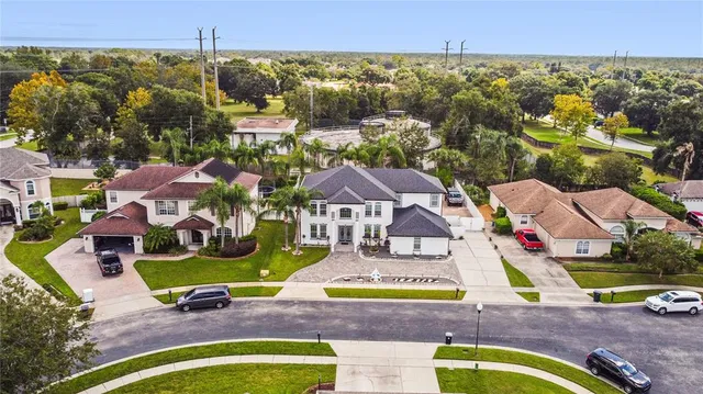 an aerial view of residential houses with outdoor space and swimming pool