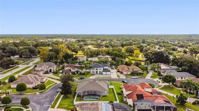 an aerial view of residential houses with outdoor space and swimming pool