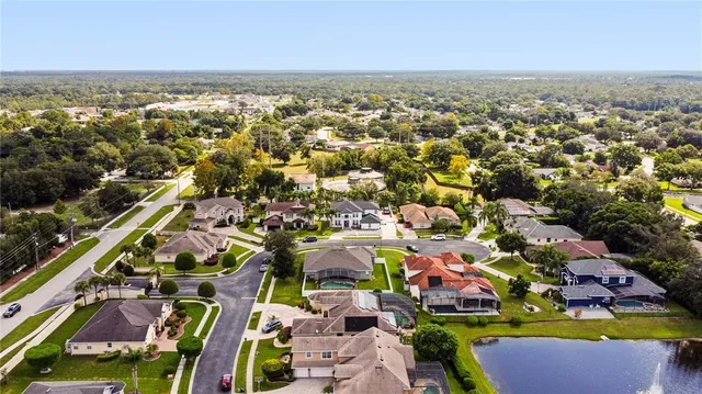an aerial view of multiple houses with a street