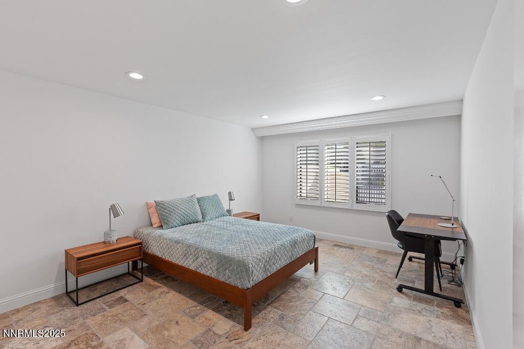 4811 Lakeridge Terrace West Reno, NV 89509 - Photo 30 of 43 a bedroom with a bed a table and a window