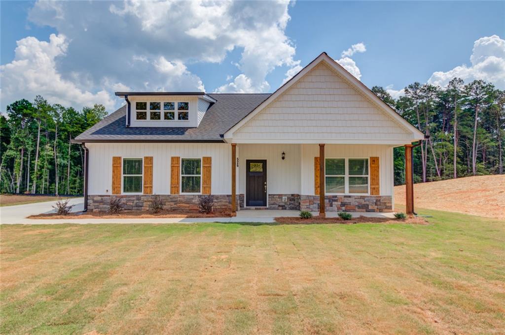 0 Harvest Church Road, Unit 1 Clarkesville, GA 30523 - Photo 2 of 38 a front view of a house with a yard outdoor seating and garage