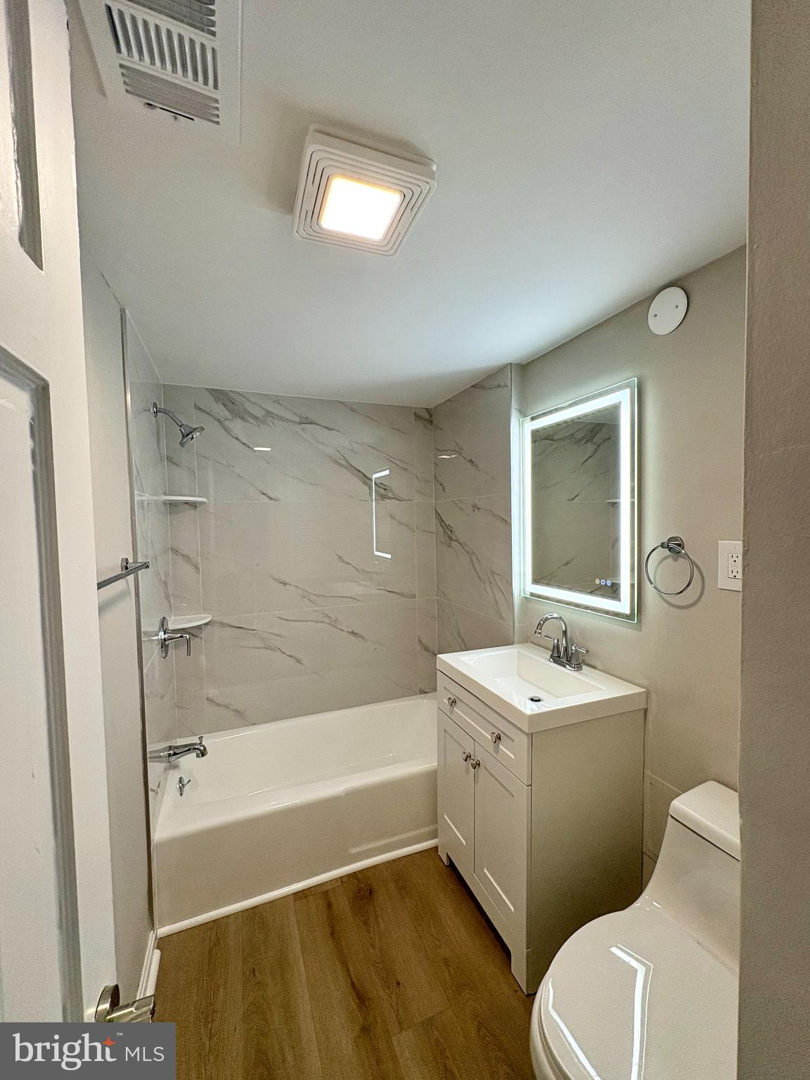 2008 38th Street Southeast, Unit 302 Washington, DC 20020 - Photo 12 of 25 a bathroom with a sink a toilet and shower