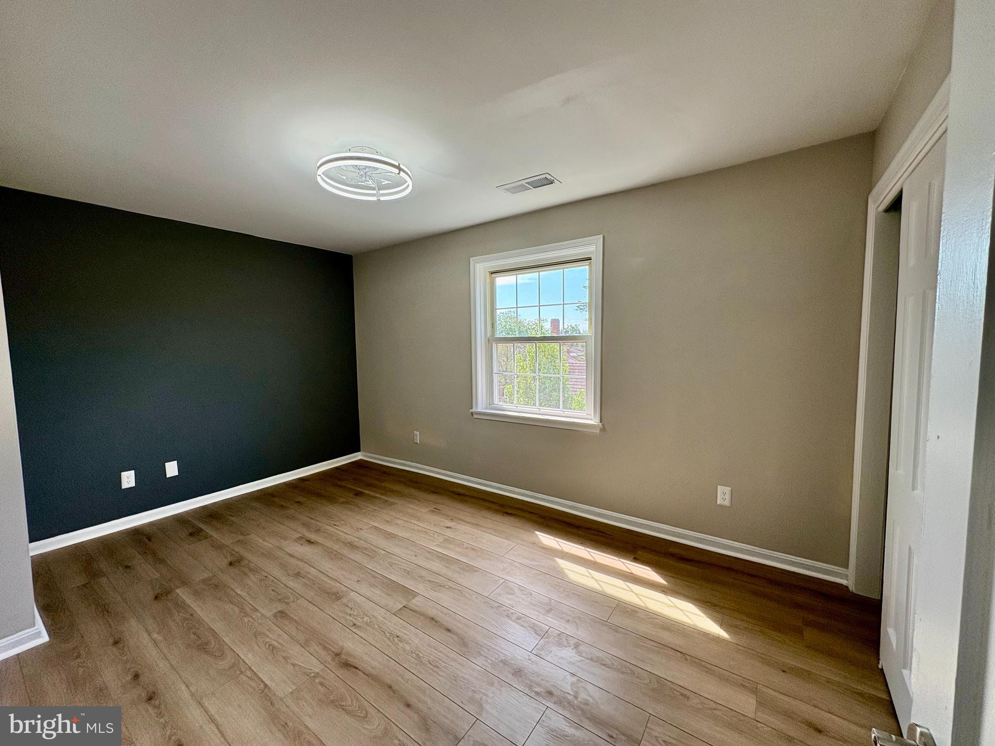 2008 38th Street Southeast, Unit 302 Washington, DC 20020 - Photo 16 of 25 an empty room with wooden floor and windows
