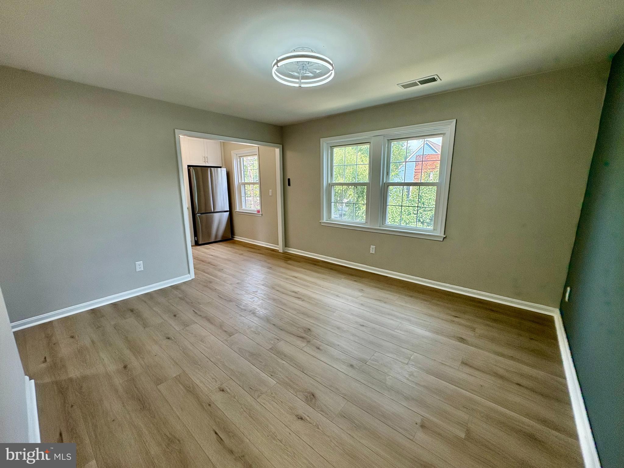 2008 38th Street Southeast, Unit 302 Washington, DC 20020 - Photo 4 of 25 an empty room with wooden floor and windows