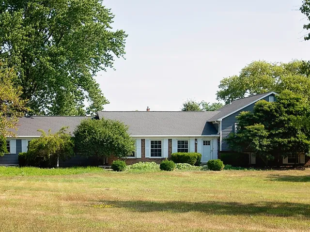 a front view of a house with garden