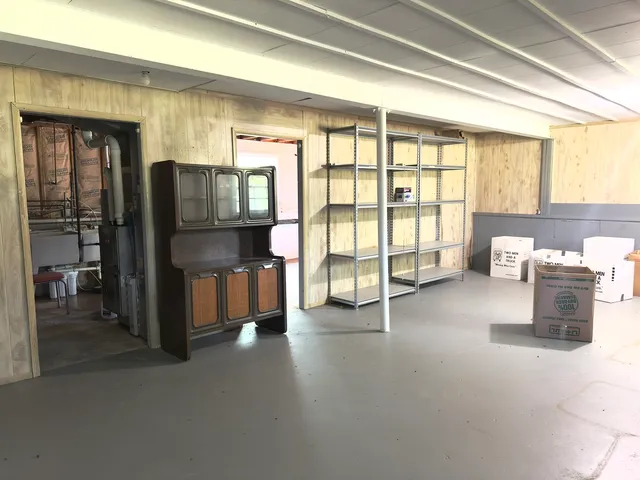 a view of a livingroom with furniture and a large window