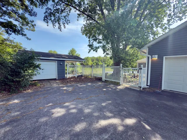 a view of a house with a tree and fence
