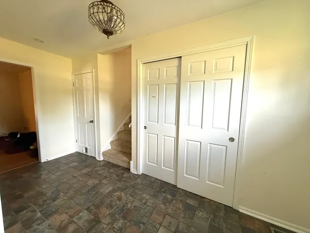 an entryway to room with wooden floor