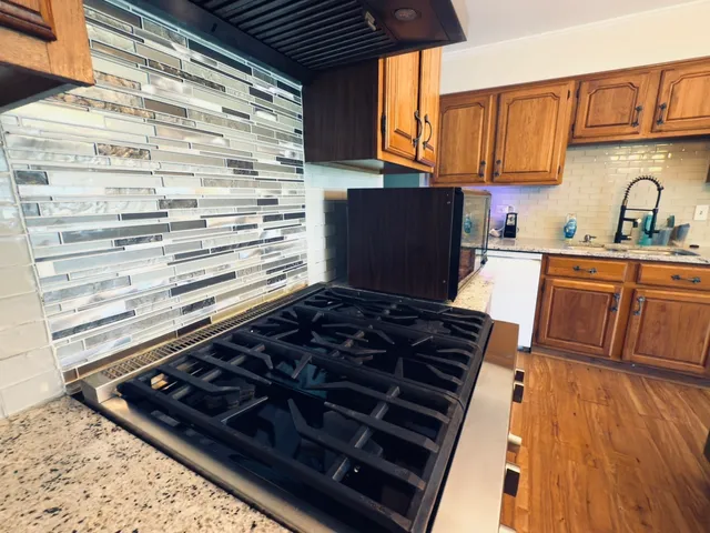 a kitchen with wooden cabinets and a stove top oven