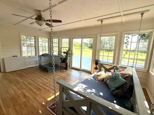 a living room with furniture floor to ceiling window and floor to ceiling window
