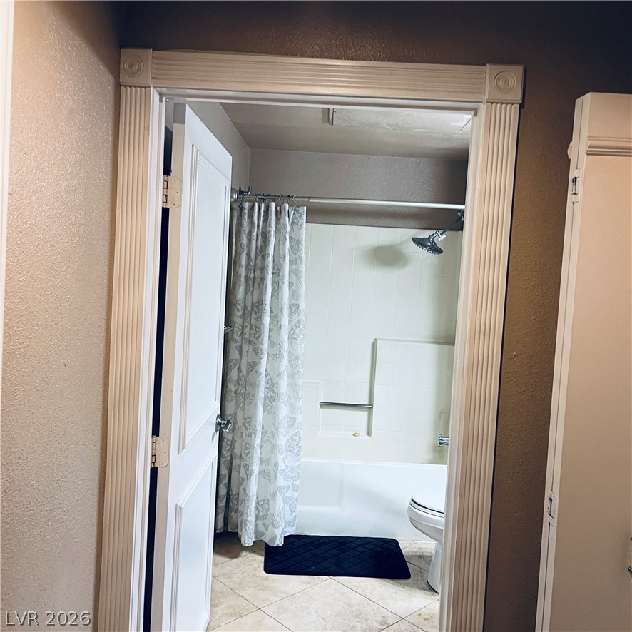 260 East Flamingo Road, Unit 118 Las Vegas, NV 89169 - Photo 9 of 9 Enter a well-appointed bathroom featuring classic tile flooring and a tub with an overhead shower.