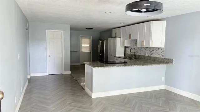 a kitchen with a stove and a refrigerator