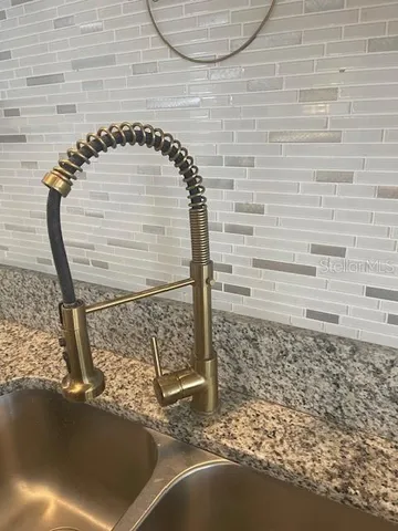 a view of a hallway with wooden floor and a bathroom